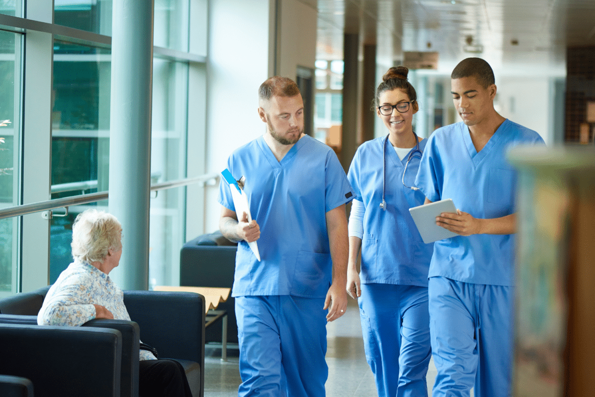 Three doctors walking together in a hospital