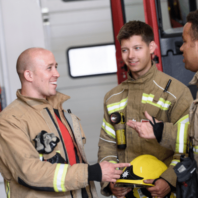 Three firefighters talking together